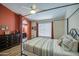 This spacious main bedroom features wood-look floors, an ensuite bathroom, and a metal canopy bed at 1853 W Estrella Dr, Chandler, AZ 85224