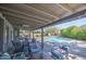 Spacious patio area with comfortable seating and view of the backyard pool and landscaping at 1853 W Estrella Dr, Chandler, AZ 85224