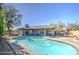 Inviting backyard oasis features a sparkling pool, spa, and lush landscaping, perfect for relaxation and entertaining at 1853 W Estrella Dr, Chandler, AZ 85224