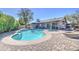 Inviting backyard pool with a spa and a charming stone fire pit surrounded by a brick patio at 1853 W Estrella Dr, Chandler, AZ 85224