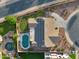Aerial view of a home with a private pool, well-maintained landscaping, and solar panels on the roof at 18611 E Raven Dr, Queen Creek, AZ 85142