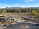 Scenic aerial view of landscaped property, neighborhood, playground and mountains in the distance at 18611 E Raven Dr, Queen Creek, AZ 85142