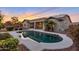 Inviting backyard with a pool, featuring a tranquil atmosphere and tasteful landscaping for outdoor enjoyment at 18611 E Raven Dr, Queen Creek, AZ 85142