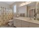 Bathroom featuring a vanity with a sink, a toilet, and a shower with a patterned shower curtain at 18611 E Raven Dr, Queen Creek, AZ 85142