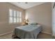 Cozy bedroom featuring shutters on the window and a comfortable queen-sized bed with neutral decor at 18611 E Raven Dr, Queen Creek, AZ 85142