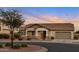 Charming single-story home boasting manicured landscaping, neutral colors, and a two-car garage at 18611 E Raven Dr, Queen Creek, AZ 85142