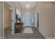 Bright foyer with elegant chandelier, neutral walls, and decorative console table at 18611 E Raven Dr, Queen Creek, AZ 85142