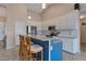 Spacious kitchen with stainless steel appliances, an island with seating, and white cabinetry at 18611 E Raven Dr, Queen Creek, AZ 85142