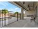 Relax on this covered patio, featuring ceiling fans, overlooking the fenced pool and nicely landscaped backyard at 18611 E Raven Dr, Queen Creek, AZ 85142