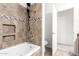 Bathroom featuring a tiled shower with a handheld shower and a separate toilet area at 1920 E Belmont Dr, Tempe, AZ 85284
