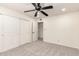 Spacious bedroom with neutral carpet, ceiling fan, and closet at 1920 E Belmont Dr, Tempe, AZ 85284