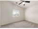 Bedroom includes neutral carpet, window with blinds, and a ceiling fan at 1920 E Belmont Dr, Tempe, AZ 85284