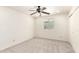 Bright bedroom with neutral carpet, ceiling fan, and closet at 1920 E Belmont Dr, Tempe, AZ 85284