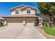 Traditional two story home with tan stucco, tile roof, three car garage, and front yard landscaping at 1920 E Belmont Dr, Tempe, AZ 85284