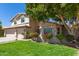 Inviting home with a well-manicured lawn, beautiful landscaping, and a spacious three-car garage at 1920 E Belmont Dr, Tempe, AZ 85284