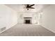 Bright living room showcases fireplace, ceiling fan, plush carpeting, and natural light from the windows at 1920 E Belmont Dr, Tempe, AZ 85284