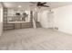 Open living room features built-in shelving, plush carpet, and a view of the staircase at 1920 E Belmont Dr, Tempe, AZ 85284