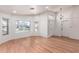 Inviting living room with hardwood floors, large windows, and elegant light fixture at 1920 E Belmont Dr, Tempe, AZ 85284