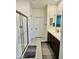 Bathroom featuring a glass shower, double vanity, and a door leading to a separate toilet room at 20610 W Vermont Ave, Buckeye, AZ 85396