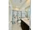 Bright bathroom featuring a vanity, shower with a decorative curtain, and a neutral color palette at 20610 W Vermont Ave, Buckeye, AZ 85396