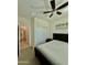 Bedroom featuring a closet, bed, ceiling fan, and ensuite bathroom, with neutral paint and carpet at 20610 W Vermont Ave, Buckeye, AZ 85396
