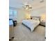 Bright bedroom features a ceiling fan, window with shutters, upholstered headboard, and side tables with lamps at 20610 W Vermont Ave, Buckeye, AZ 85396