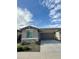 Charming single-story home with a stone facade, well-manicured landscaping, and a spacious two-car garage at 20610 W Vermont Ave, Buckeye, AZ 85396