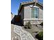 Charming single-story home featuring a stone facade, a wooden gate and a nicely landscaped walkway at 20610 W Vermont Ave, Buckeye, AZ 85396