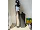 Garage containing a water purification system, including a water softener, and potting supplies at 20610 W Vermont Ave, Buckeye, AZ 85396