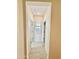 Hallway with light tile floors and a window with shutters at the end at 20610 W Vermont Ave, Buckeye, AZ 85396
