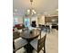 Open floor plan integrating the dining area, living room and kitchen, ideal for modern living and entertaining at 20610 W Vermont Ave, Buckeye, AZ 85396