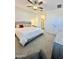 View of main bedroom featuring a ceiling fan, upholstered headboard, side tables, and ensuite bathroom at 20610 W Vermont Ave, Buckeye, AZ 85396