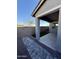Covered back patio with low-maintenance landscaping and a block fence for added privacy at 20610 W Vermont Ave, Buckeye, AZ 85396