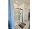 Bathroom featuring a glass shower and a dark gray floor mat at 20610 W Vermont Ave, Buckeye, AZ 85396