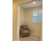 Cozy sitting area with an accent chair and a window with shutters at 20610 W Vermont Ave, Buckeye, AZ 85396