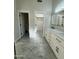Bright bathroom featuring marble floors, double vanity with brushed gold hardware, and access to a walk-in closet and toilet room at 20822 N 42Nd. Ave, Glendale, AZ 85308