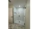Bathroom featuring a glass enclosed shower with white wave tile surround and bronze hardware at 20822 N 42Nd. Ave, Glendale, AZ 85308