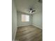 Bedroom featuring a ceiling fan, a window with blinds, and light wood-look floors at 20822 N 42Nd. Ave, Glendale, AZ 85308