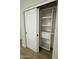 Walk-in closet featuring a sliding door and custom shelving system at 20822 N 42Nd. Ave, Glendale, AZ 85308