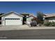Charming single-story home with a two-car garage and desert landscaping in the front yard at 20822 N 42Nd. Ave, Glendale, AZ 85308