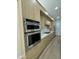 Modern kitchen features stainless steel appliances, sleek cabinetry, and light countertops at 20822 N 42Nd. Ave, Glendale, AZ 85308