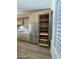 Open pantry features shelving and drawers, adjacent to stainless steel refrigerator at 20822 N 42Nd. Ave, Glendale, AZ 85308