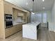 Stylish kitchen with a center island, stainless steel appliances, and light wood cabinetry at 20822 N 42Nd. Ave, Glendale, AZ 85308
