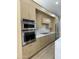 Modern kitchen with stainless steel appliances, light wood cabinetry, and white countertops and backsplash at 20822 N 42Nd. Ave, Glendale, AZ 85308