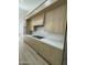 Contemporary kitchen features sleek wooden cabinets, white countertops and backsplash, and modern appliances at 20822 N 42Nd. Ave, Glendale, AZ 85308