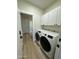 Bright laundry room featuring a front load washer and dryer and plenty of upper cabinet storage space at 20822 N 42Nd. Ave, Glendale, AZ 85308