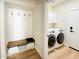 Convenient mud room with built-in bench, storage cubbies, and adjacent laundry area at 20822 N 42Nd. Ave, Glendale, AZ 85308
