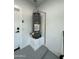 Efficient water heater installation in a well-maintained space with clean epoxy floors and a white brick wall at 20822 N 42Nd. Ave, Glendale, AZ 85308