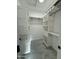 Bright walk-in closet featuring marble floors and custom white shelving, drawers, and clothing rods for ample storage at 20822 N 42Nd. Ave, Glendale, AZ 85308