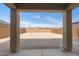 A covered back patio overlooking a spacious yard with block wall fencing, ideal for outdoor entertaining at 21572 W Sonora St, Buckeye, AZ 85326